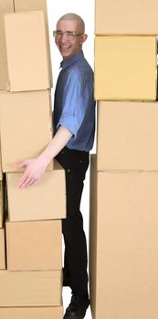 Man clamping between walls from cardboard boxes