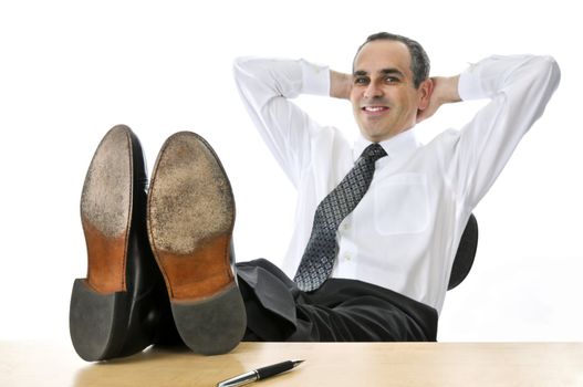 Relaxing businessman with feet up on his desk
