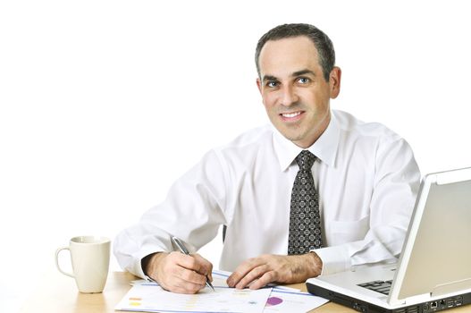 Happy office worker reviewing generic reports at his desk