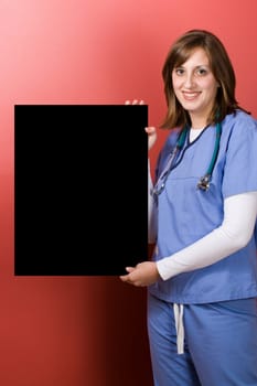 A young medical professional holding up a black sign with copyspace.