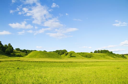 green hill blue cloudy sky