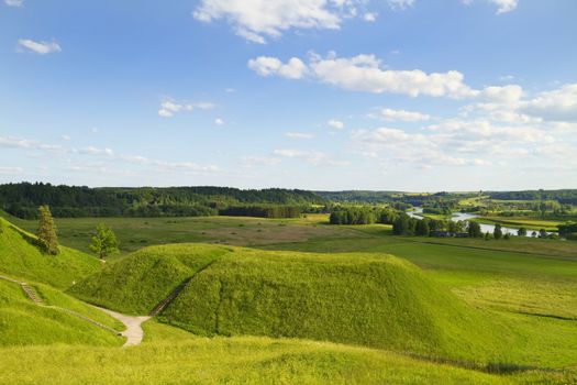 green hill blue cloudy sky