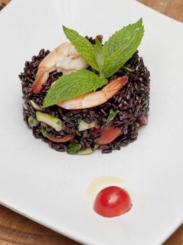 A dish of black rice, shirmos and vegetables