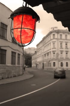 red torch on old street, sepia color