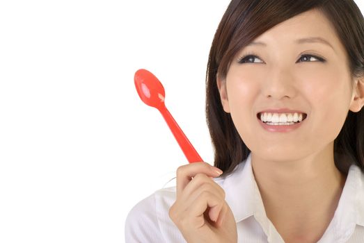 Happy business woman holding tablespoon, closeup portrait of oriental office lady on white background.