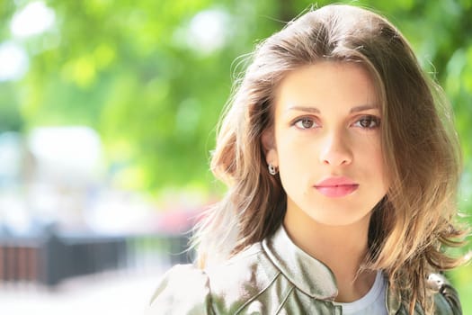 close-up portrait of the beautiful young brunette with copy-space