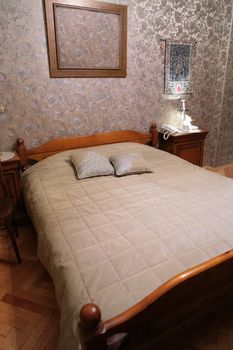 comfortable bedroom with wooden old-time bed, vintage