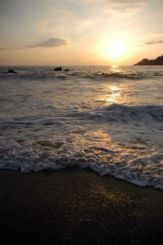 Sun comming down over the sea in Puerto Escondido, Mexico