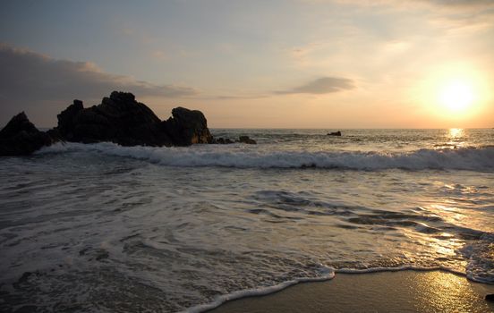 Silhouette of rockst during sunset over the beach of Puerto Escondido