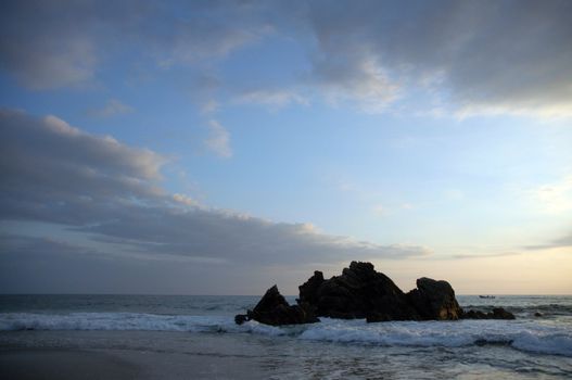 Silhouette of monument during sunset over the beach of Puerto Escondido