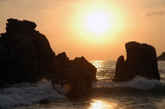 Silhouette of monument during sunset over the beach of Puerto Escondido