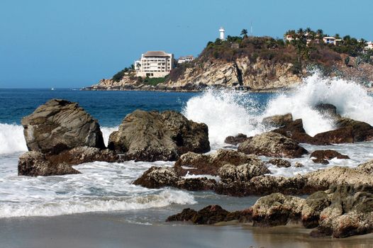 Bay in Puerto Escondido with hotel and lighthouse, Mexico