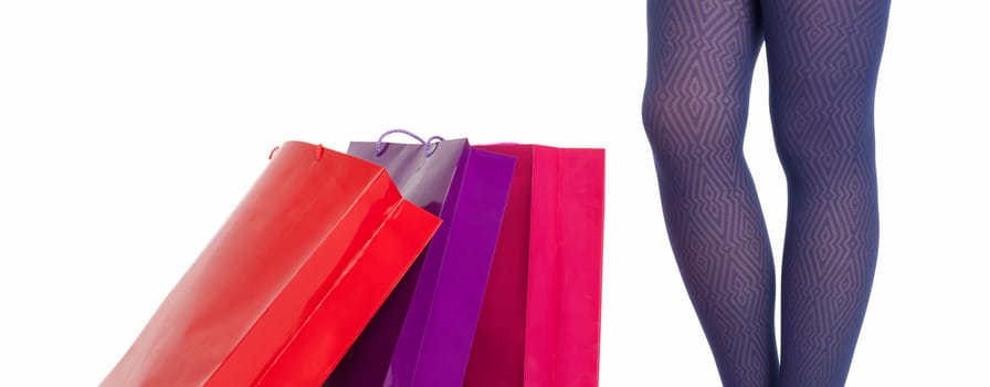 Shopping bags and woman legs wearing panties isolated on white background. Shopping concept.