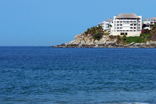 Bay in Puerto Escondido with hotel and lighthouse, Mexico