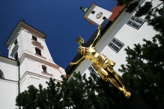 Crucifix in front of Church of Virgin Mary birth in Vranov near Brno