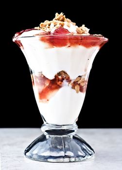 Delicious parfait with strawberry sauce, granola and vanilla yogurt.

