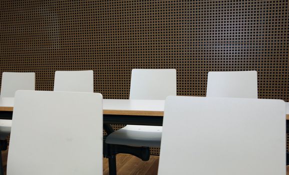 Inside of boardroom with white seats and tables