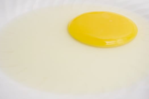 Egg yolk on a white plate.