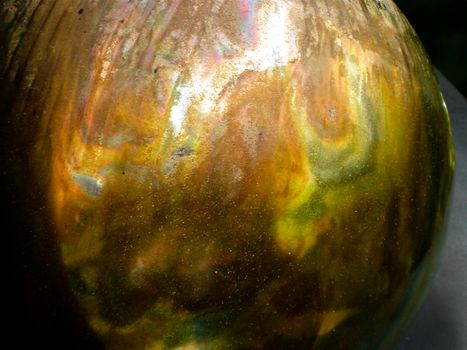 Colourful metallic ball on a grey table