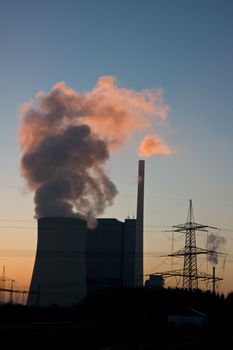 pink smoke from a power plant at sunset