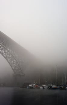 steel bridge and boats in fog