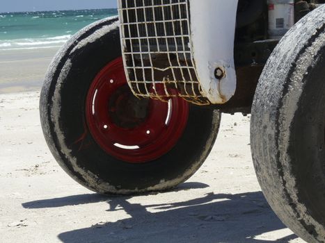 Front of an old tractor on the beach