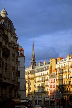 Paris street with colorful houses at sunset. France.