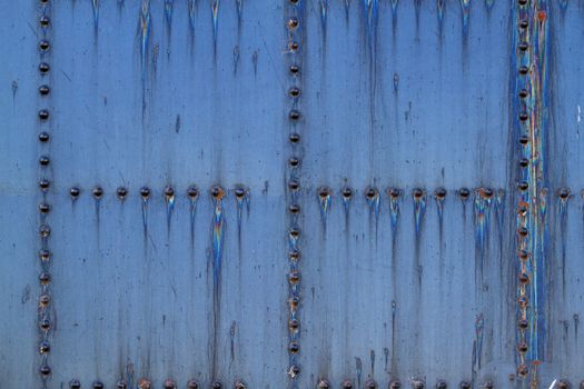 Old Stained and rusted train coal car steel plate with large rivets