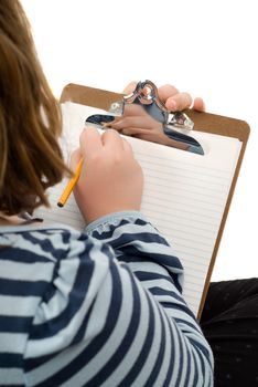An over the shoulder view of a young girl drawing something on a piece of paper