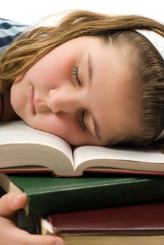 Closeup of a young girl who fell asleep on her text books