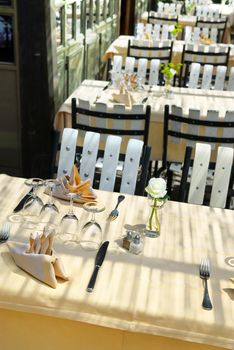 Sunlit restaurant patio with several set tables