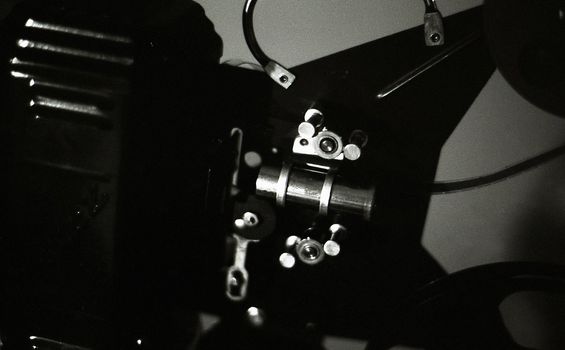 Close-up of an old 16mm film projector in black and white