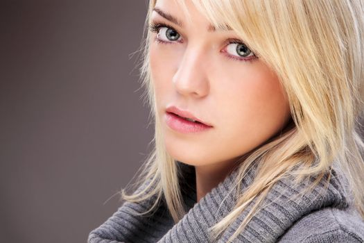 Closeup Of A Beautiful Blond Woman Wearing A Big Collar Sweater