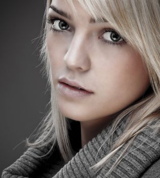 Closeup Of A Sweet Blond Girl With A Big Warm Collar Around Her Neck