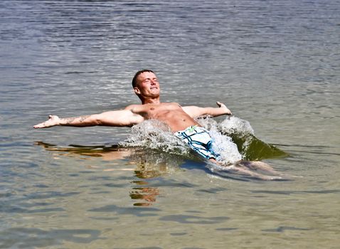 Handsome Athletic Young Man Falling Back In Water