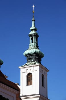 Tower of bohemian church with blue sky behind