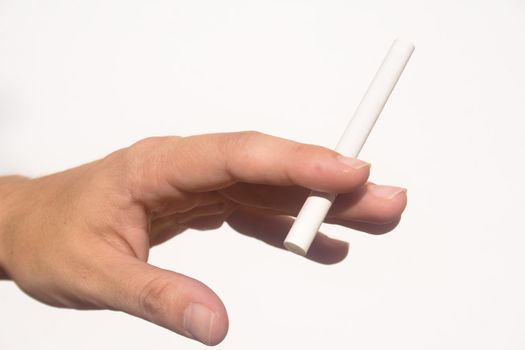 Detail of hand holding an extended cigarette against white background