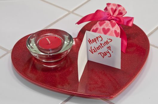 Red metallic heart dish with red candle in holder and valentine sachet with card