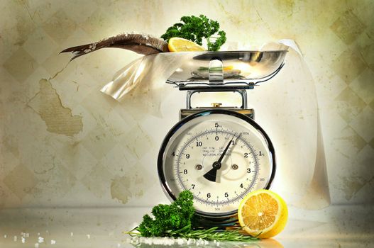 Weight scale with fish and lemons against a grungy, antique background
