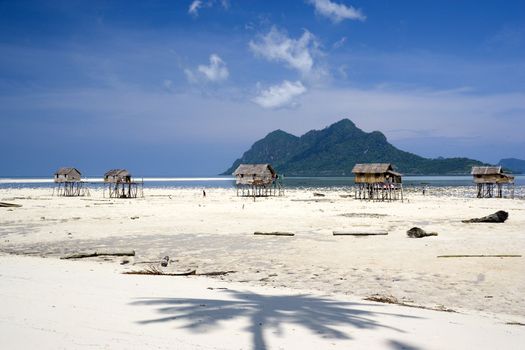 Image of native huts on stilts on a beautiful remote Malaysian island.