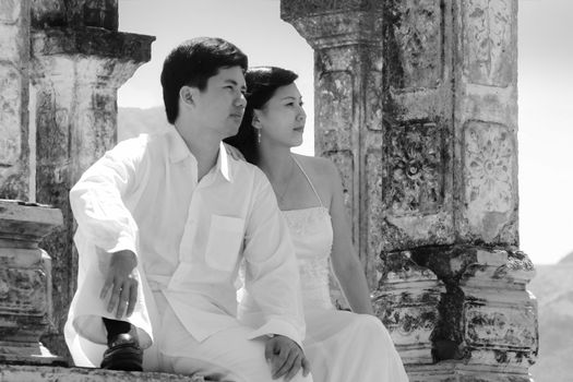 Asian couple looking away