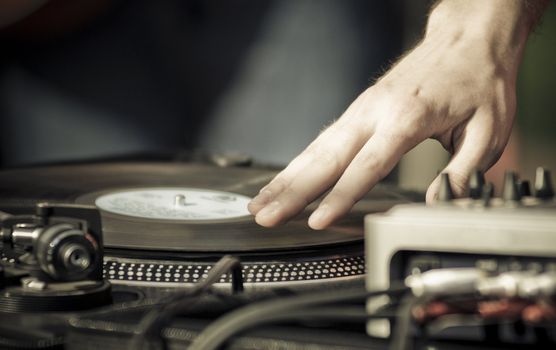 Hand scratching a record on a turntable.