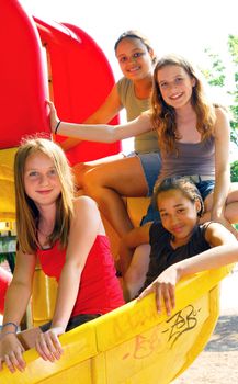 Portrait of a group of four young girls on a school playground