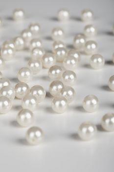 The large pearls are scattered on a grey surface