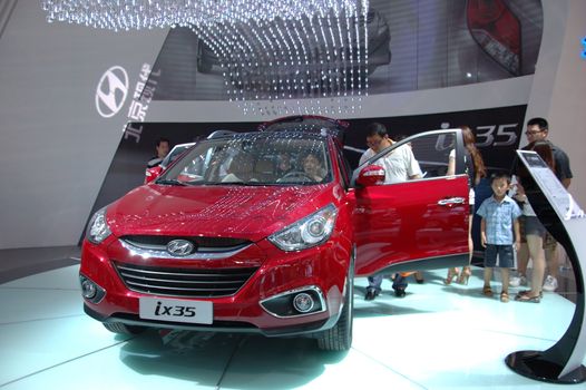 CHINA, SHENZHEN - JUNE 14: Shenzhen-Hong Kong-Macao Auto Show, Chinese family watching Hyundai on June 14, 2010 in Shenzhen.