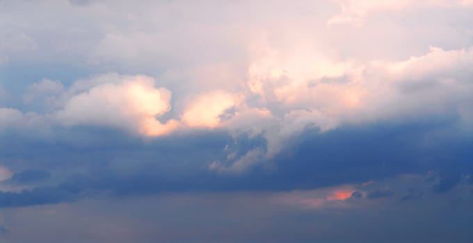 Background of stormy cloudy sky with sunlight shining through