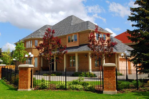Big luxury residential house with iron fence