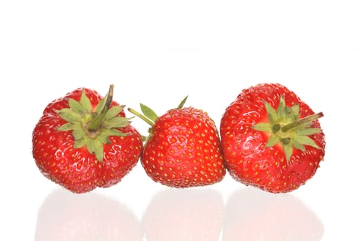 Three red freshness strawberries lying on white background