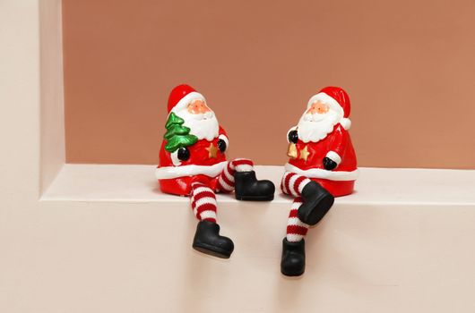 two red porcelain Santa Clauses toys sitting