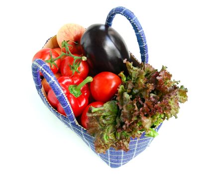Fresh vegetables and fruits in a basket isolated on white background
